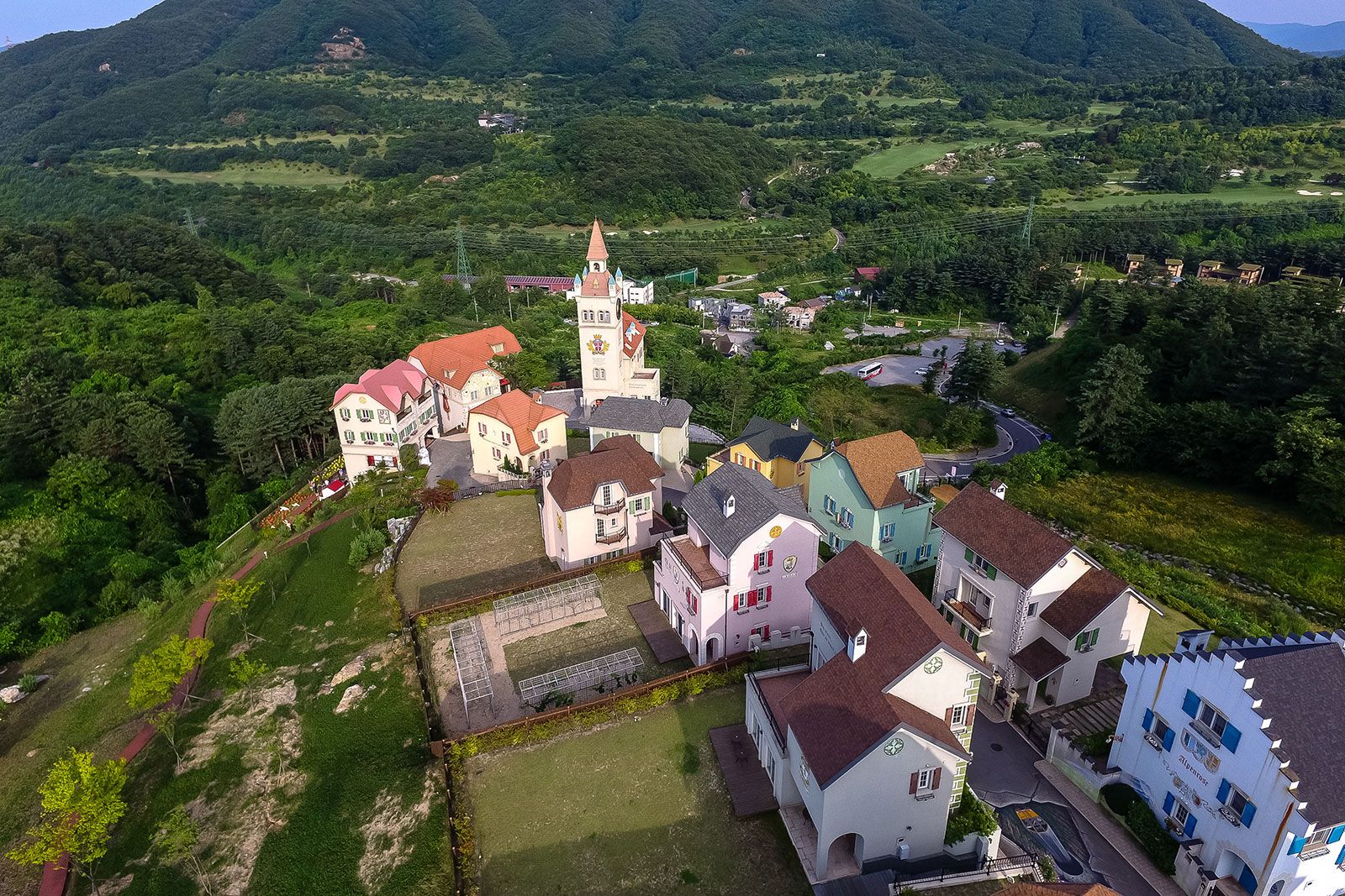 An aerial view of a village building on a hill.