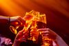 People toasting under nightclub lights.