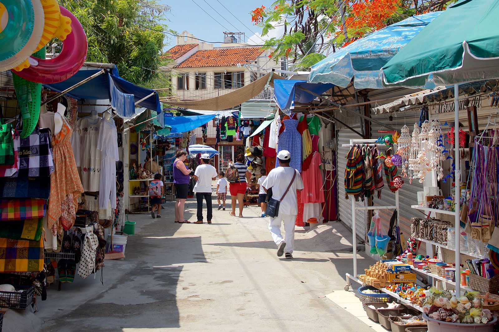 People walk down the street along markets.