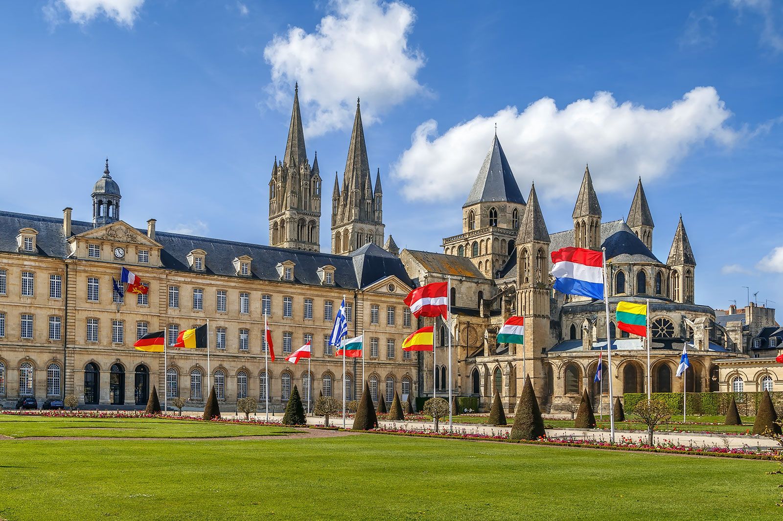 A large Abbey with flags out front.