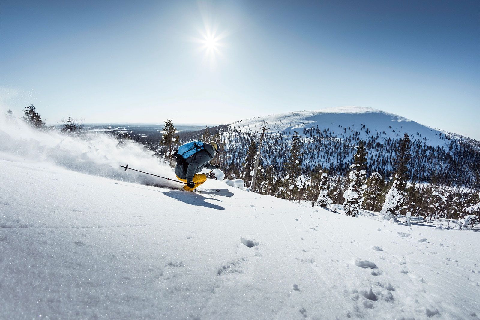 A person skis down a snowy mountain.
