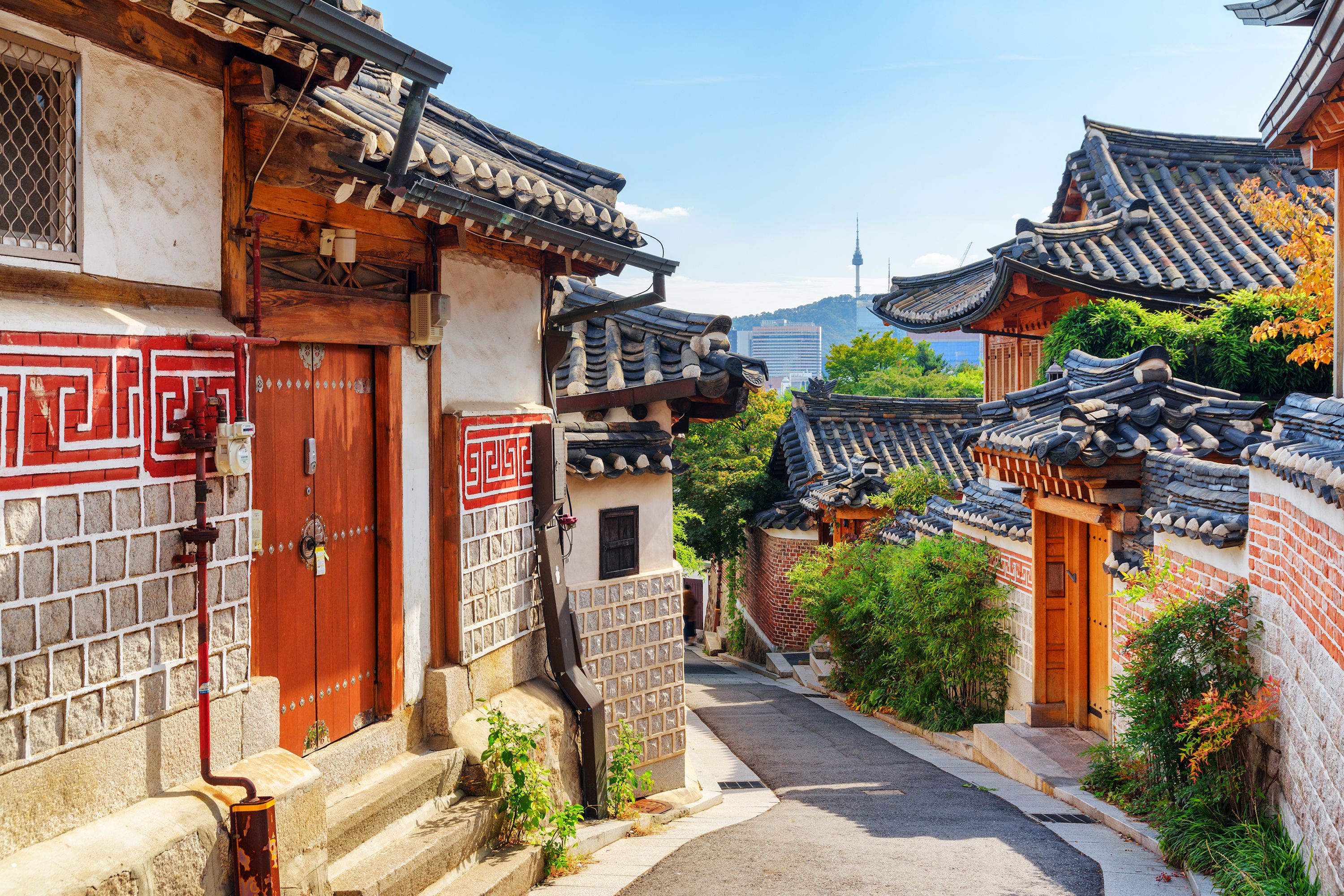 A view of traditional Hanok houses down a narrow street in Bukchon, South Korea.