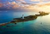 The Nassau Harbour Lighthouse on an island in the Bahamas stretching out over the water during sunset.