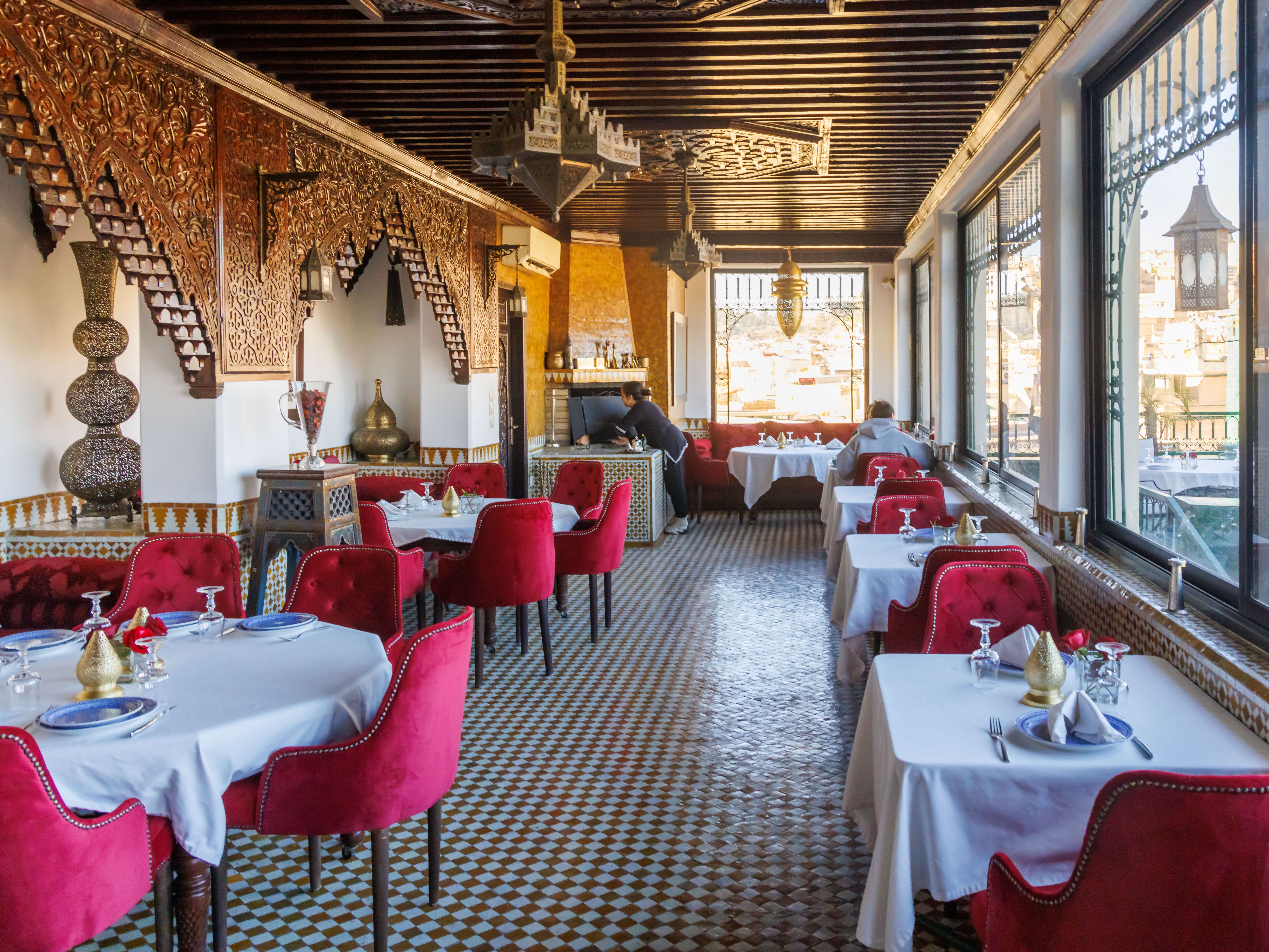 A restaurant with decorated tables and chairs in Fez. 