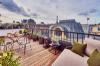 An incredible rooftop view from roof deck terrace with outdoor furniture.