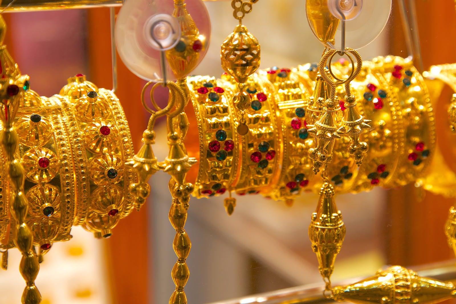 Gold bangles on display at a store.