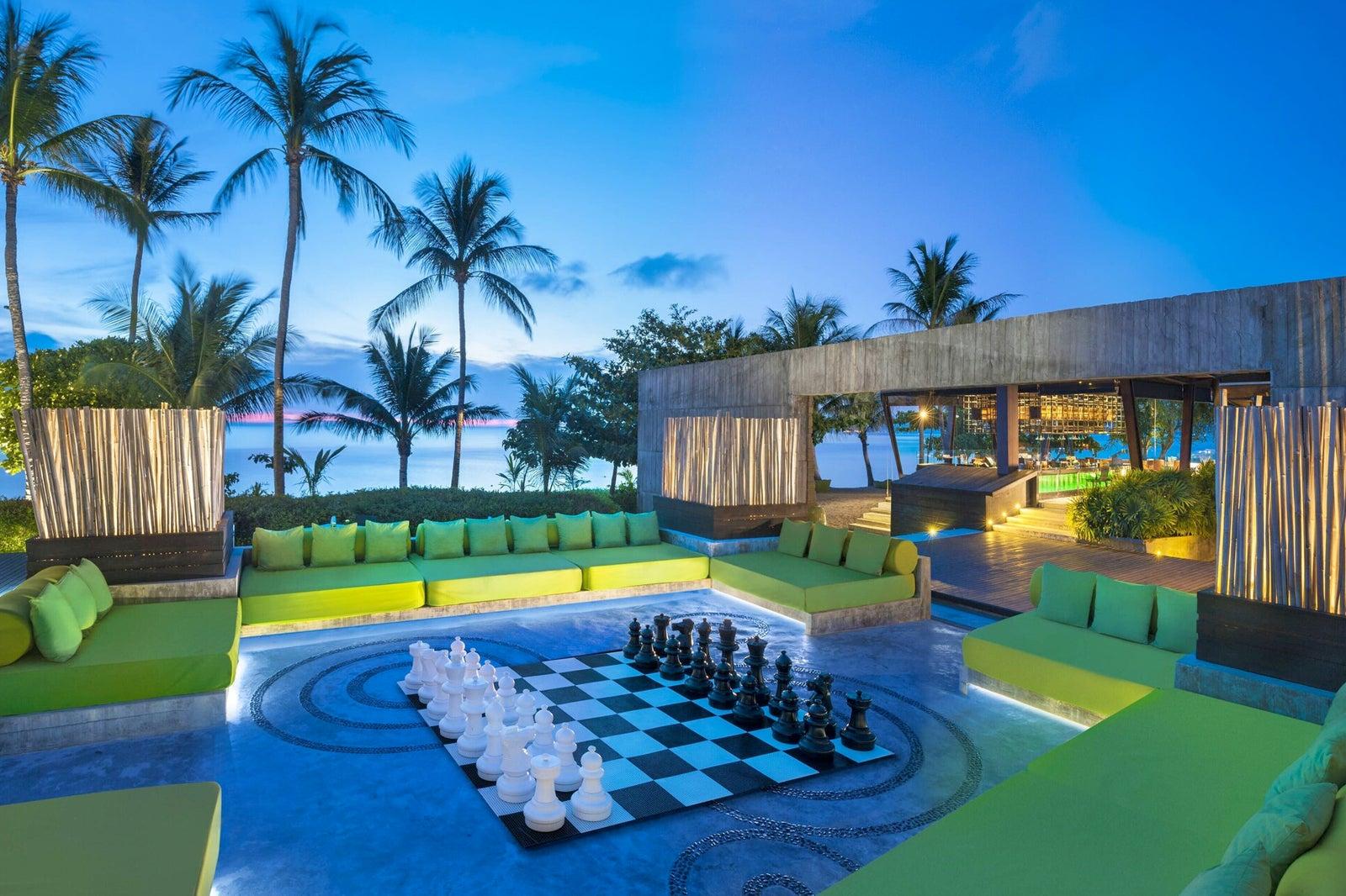 A nighttime view of a bar with a beach view.