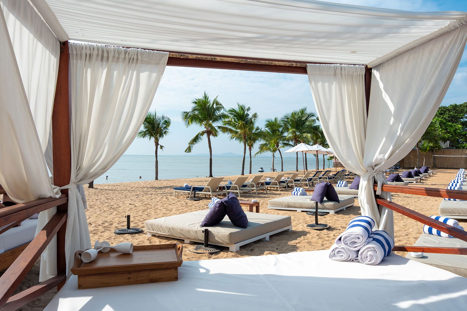 A luxury bed kept on a beach.