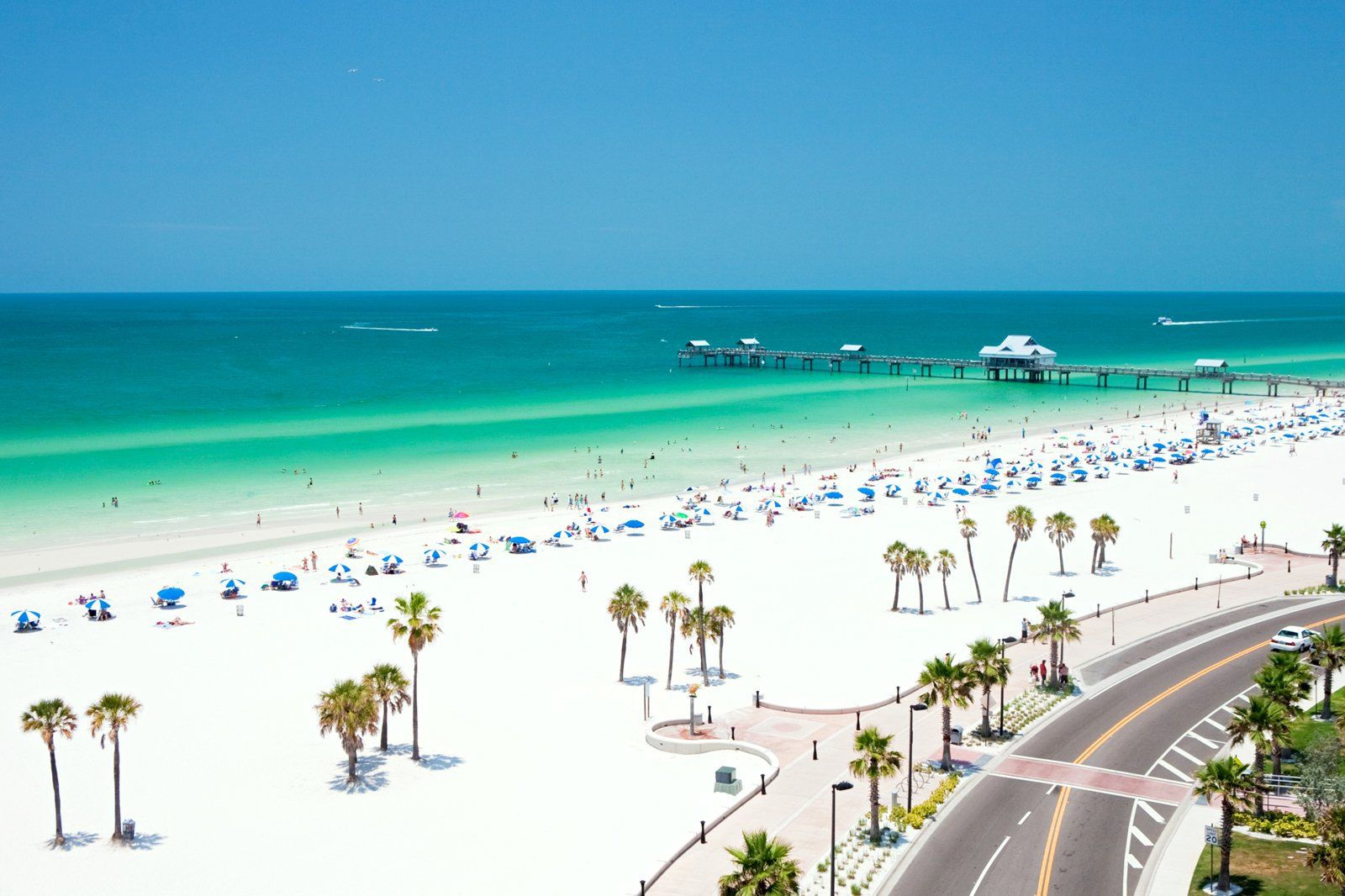 An aerial view of a beautiful beach and azure waters.