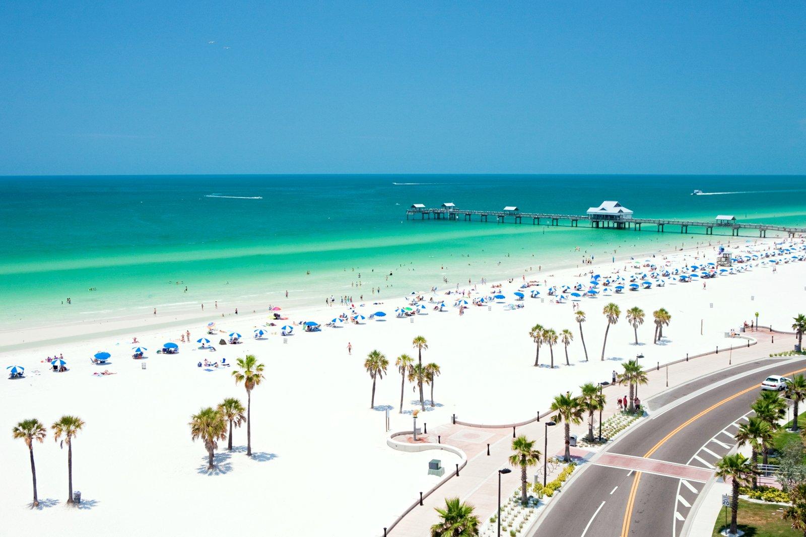 An aerial view of a beautiful beach and azure waters.