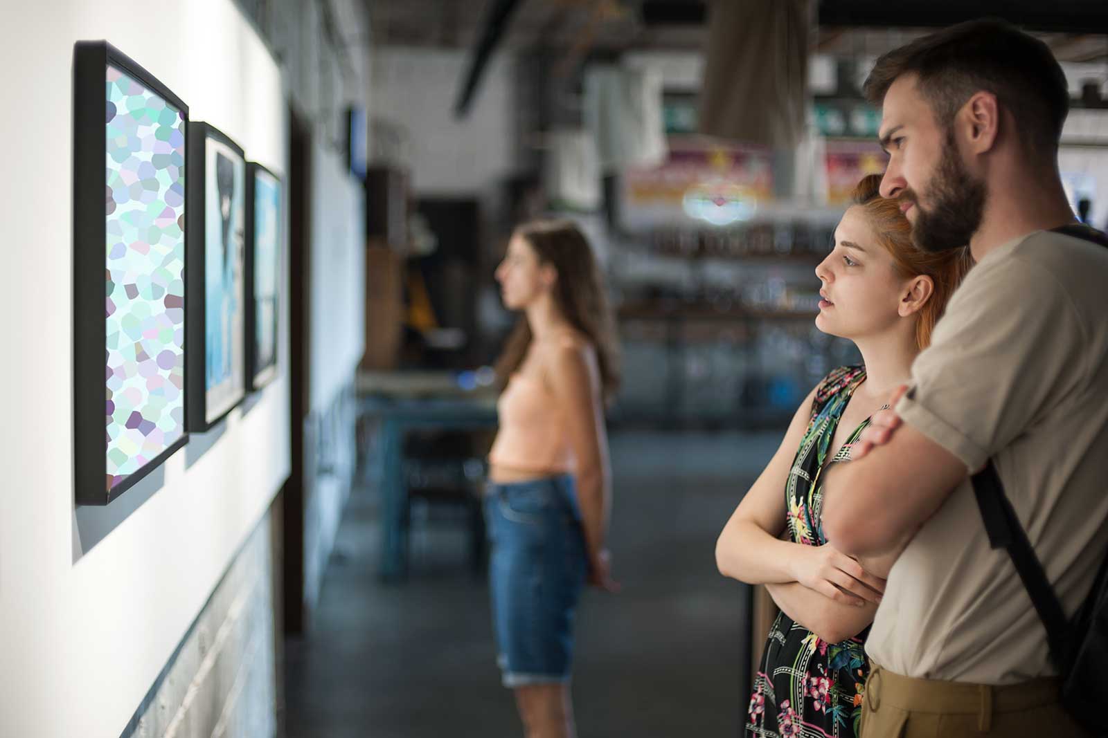A man and woman looking at art.