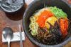 Colorful bowl of shredded vegetables and an egg yolk