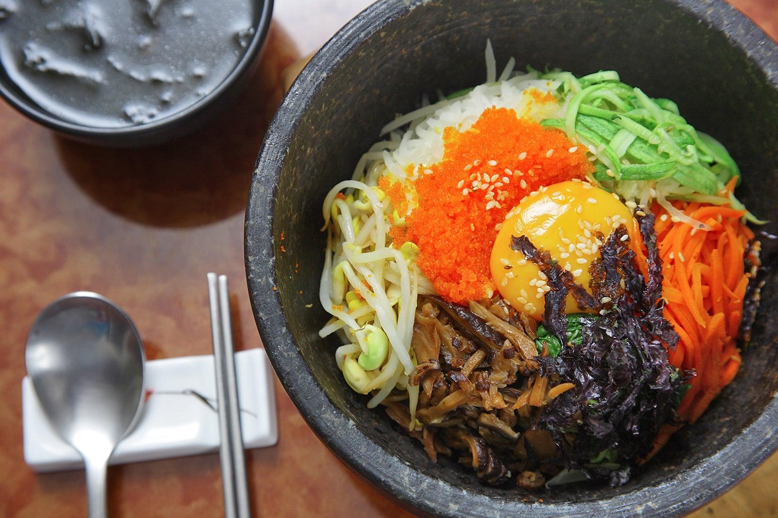Colorful bowl of shredded vegetables and an egg yolk