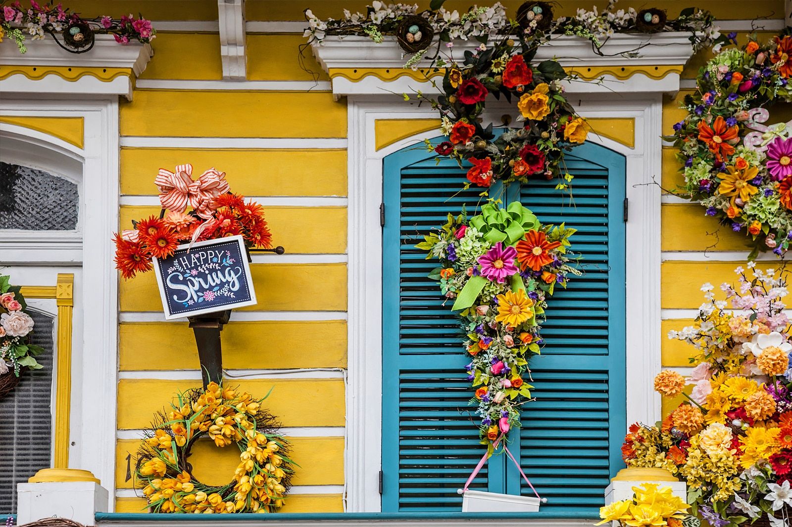 A colourful wall with a Happy Spring sign.