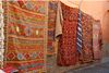 Large colorful rugs on display.