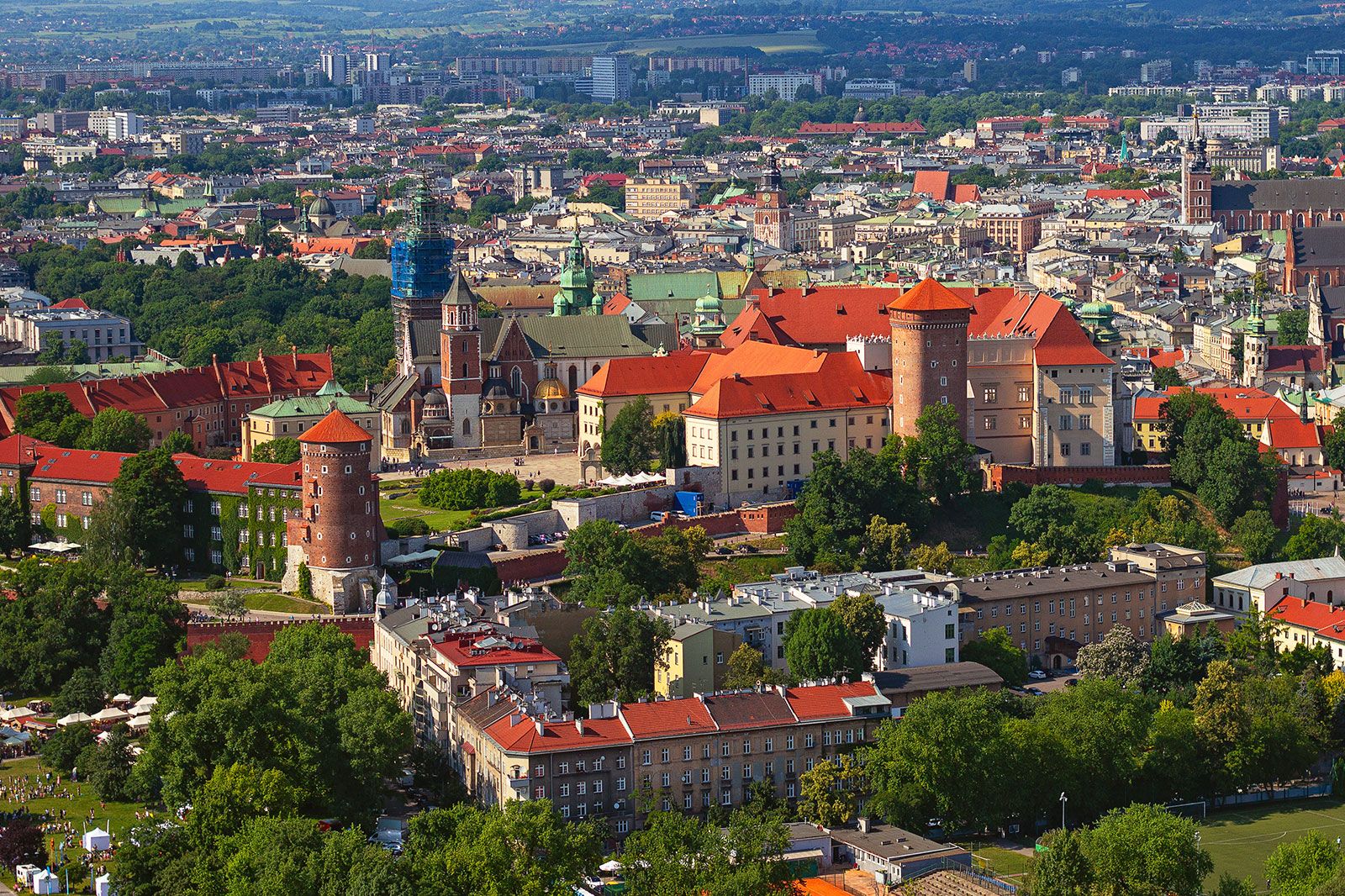 A city view of a castle with red roofs.