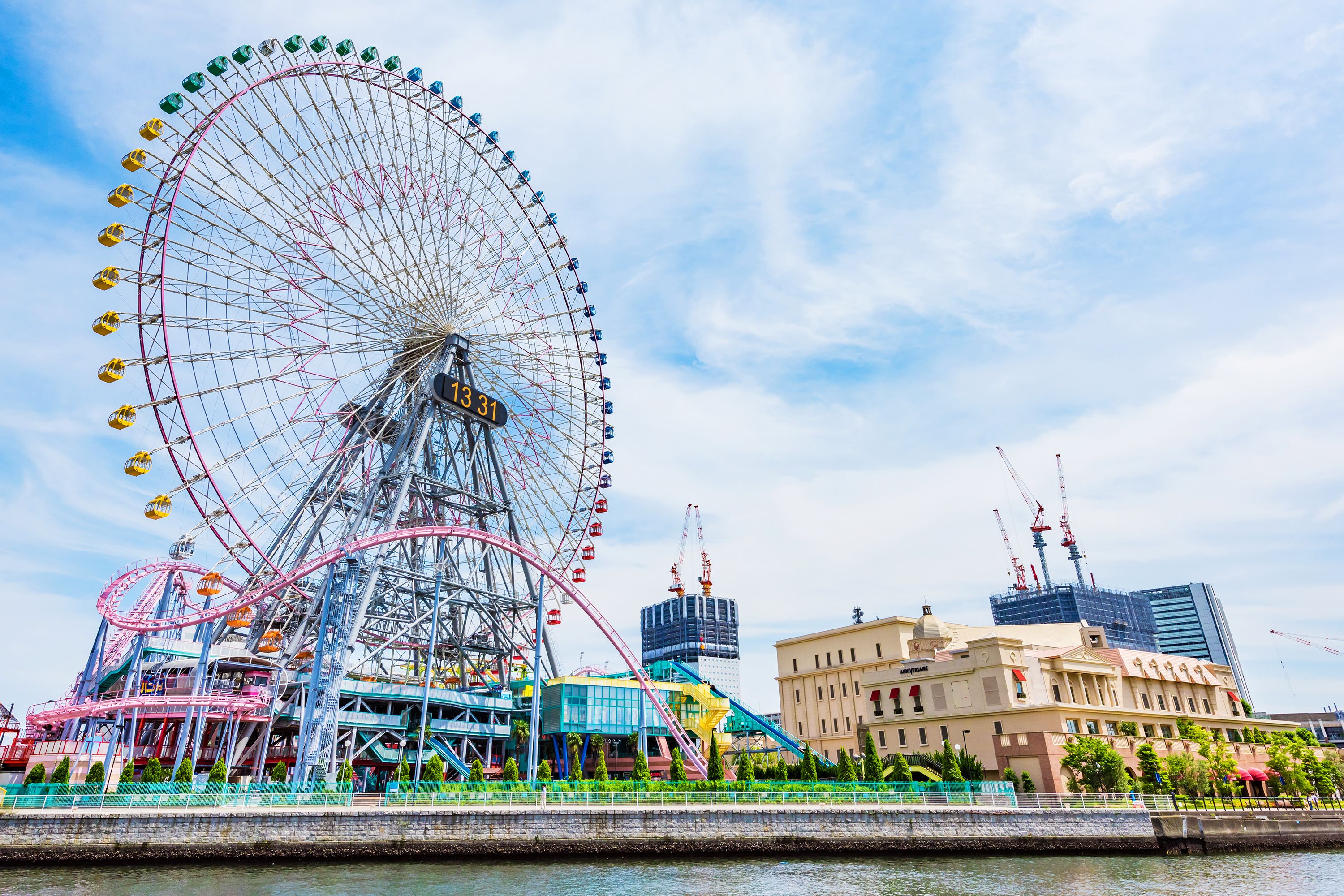 A view of the Ferris wheel and roller coaster on the water at Yokohama Cosmo World in Tokyo.