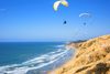 Hang gliders by the sea.