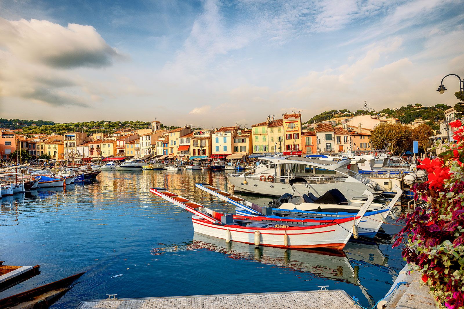 A coastal cityscape with marina in a bay.