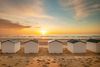 Beachhouses on the beach at sunset.