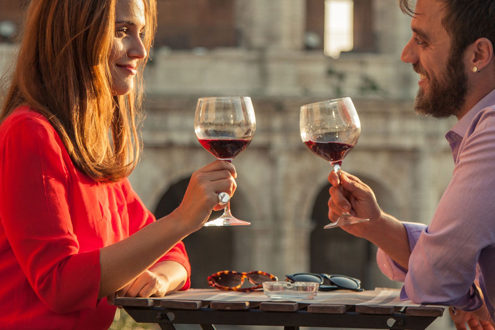 A couple drinking wine near the Colosseum.
