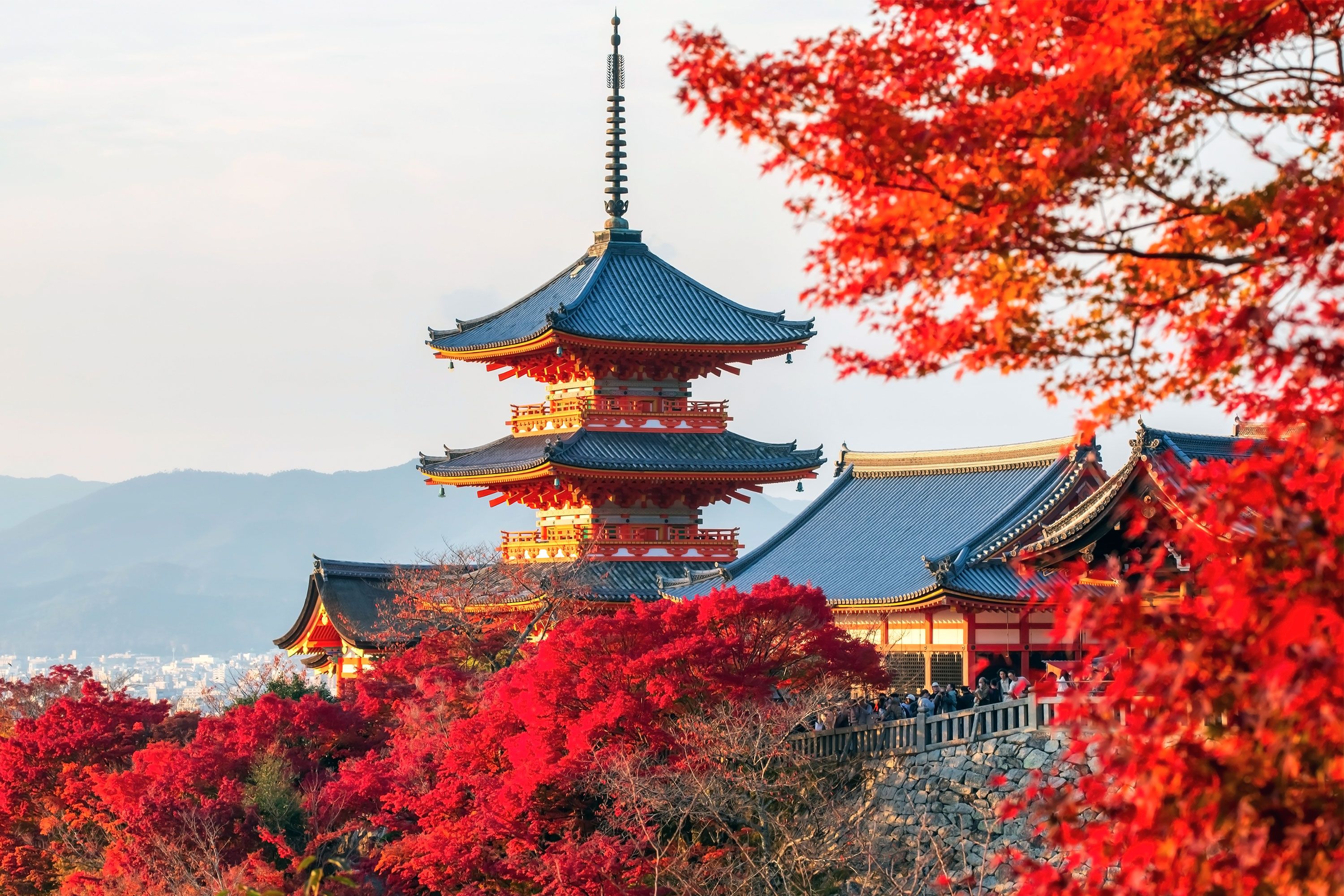 A temple with autumn foliage all around.