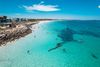 Aerial view of a beach and shipwreck.