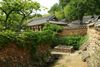 A traditional house surrounded by trees.