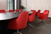 A board room with red office chairs.