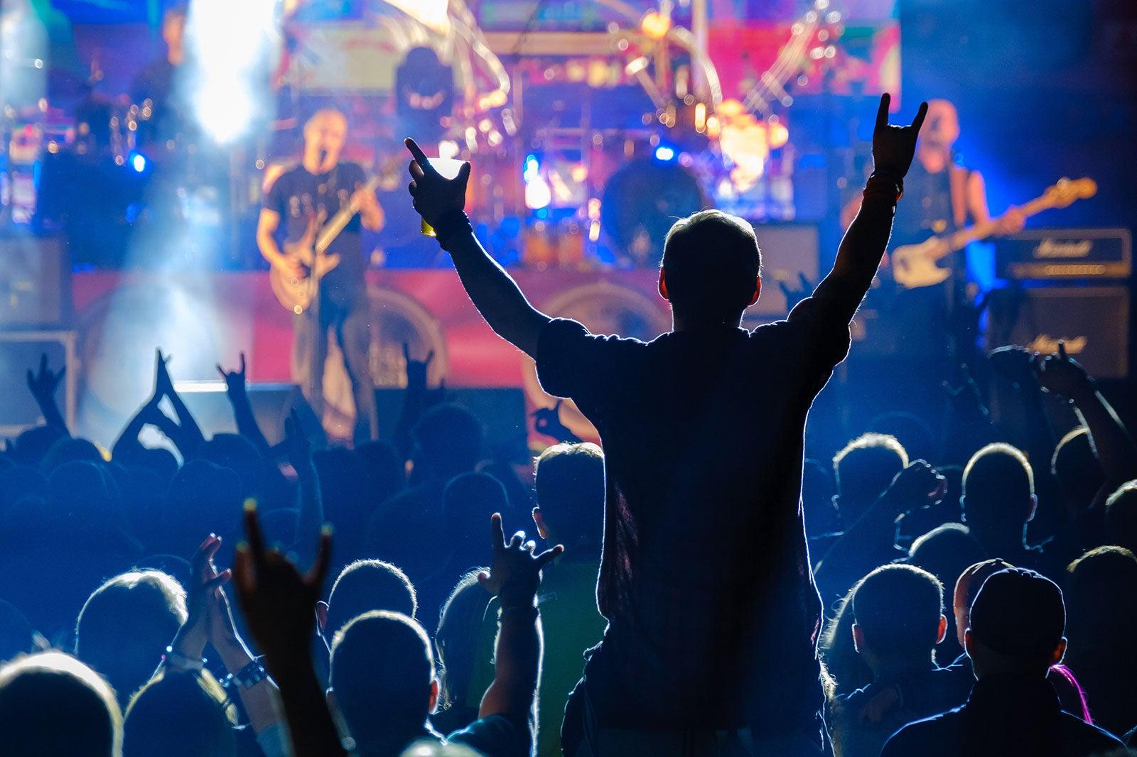 People watching a band performing on stage.