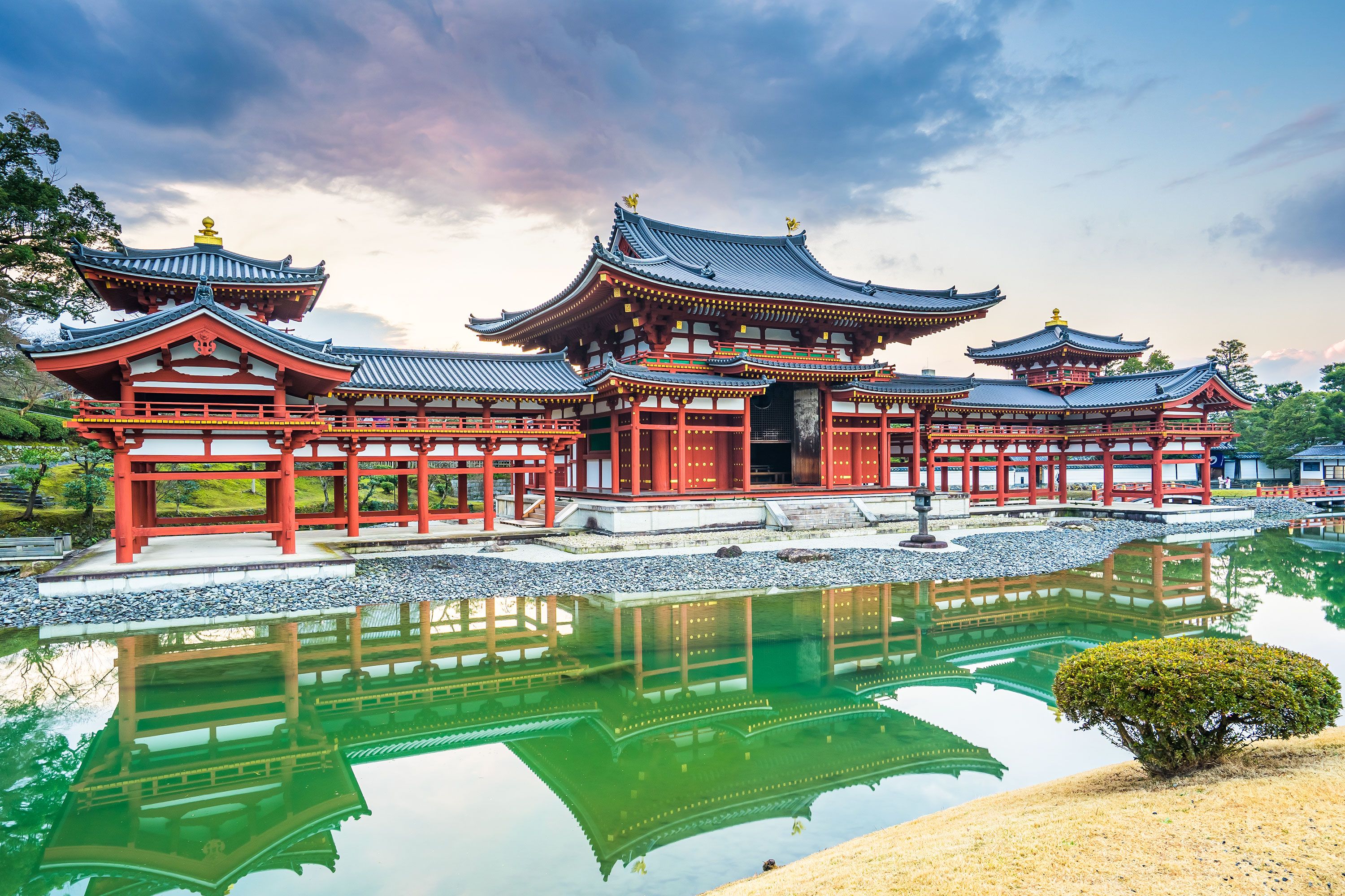 A Japanese Buddhist temple and its reflection in a pool.