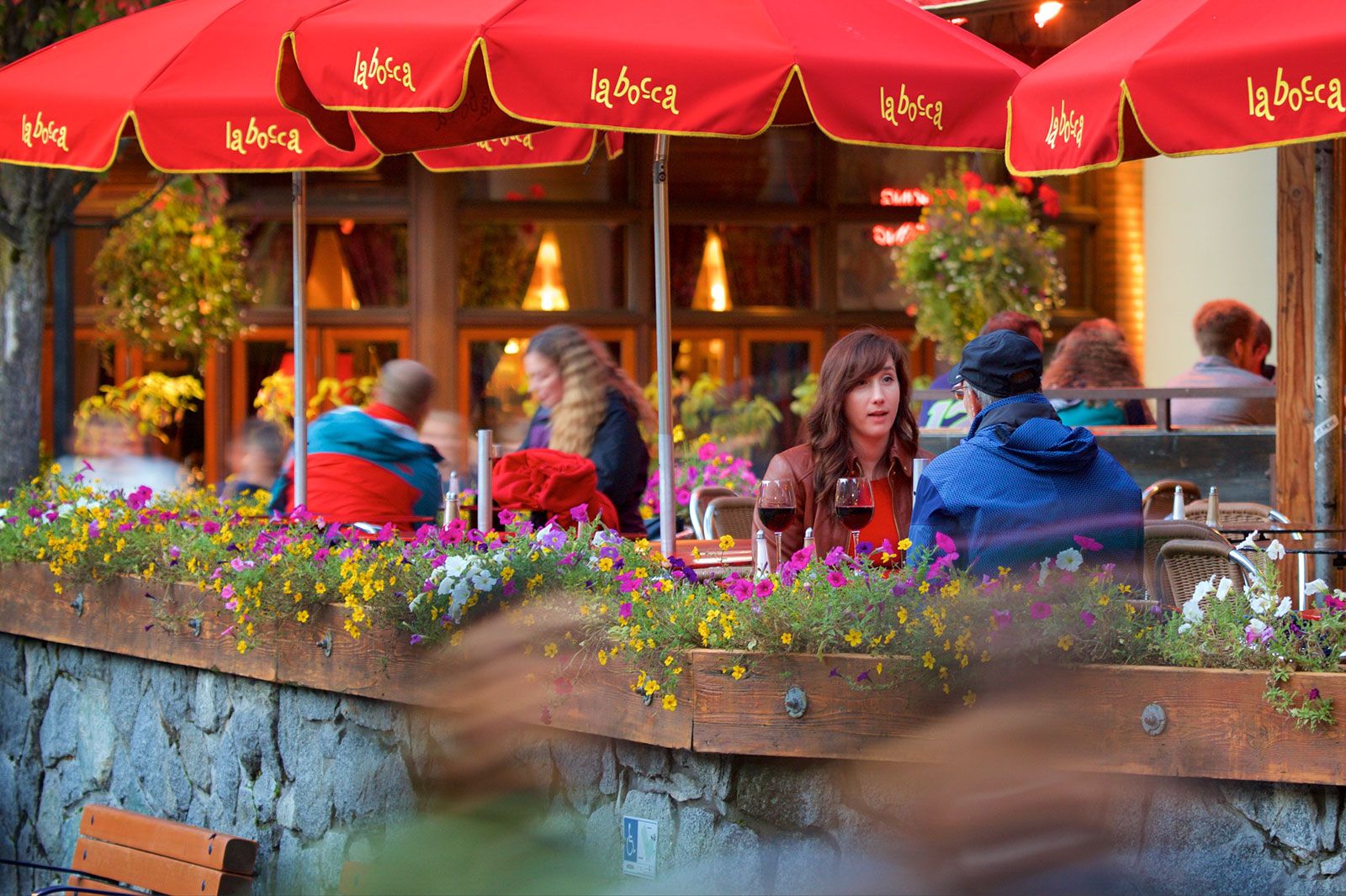 People sit at a restaurant outdoors.