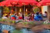 People sit at a restaurant outdoors.