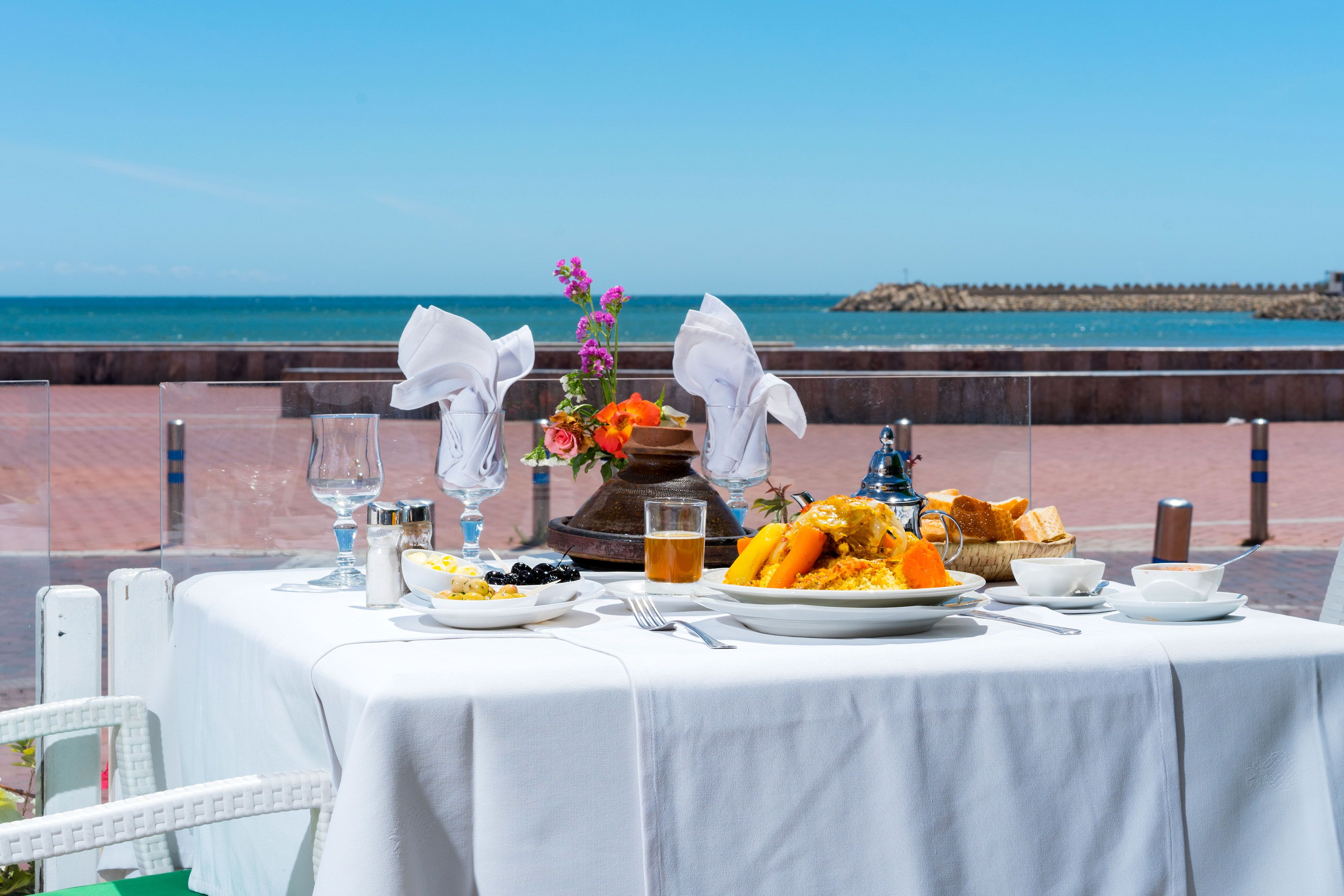 A table at a restaurant by the ocean. 