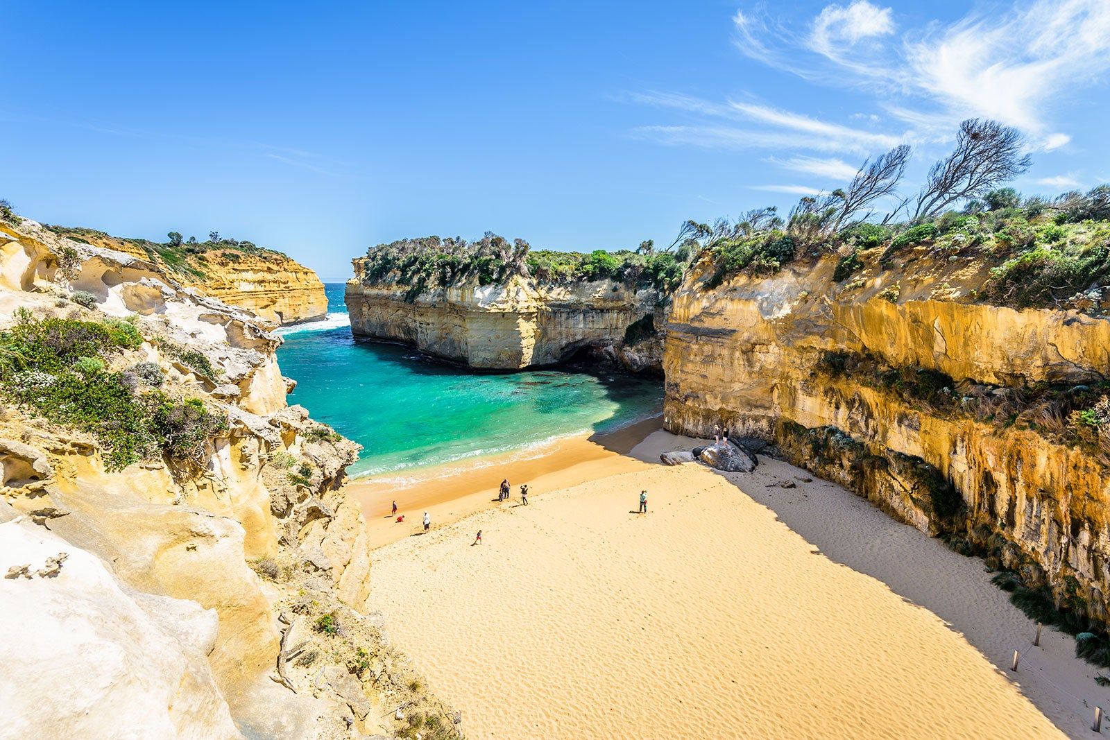 Small sandy beach surrounded by cliffs.