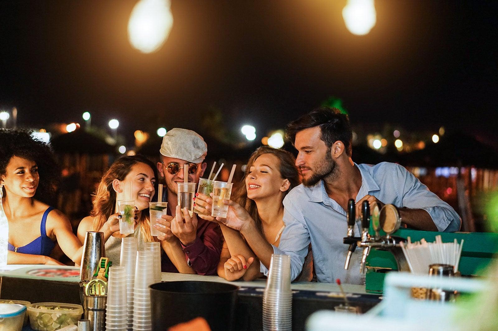 A group of people at an outside bar.