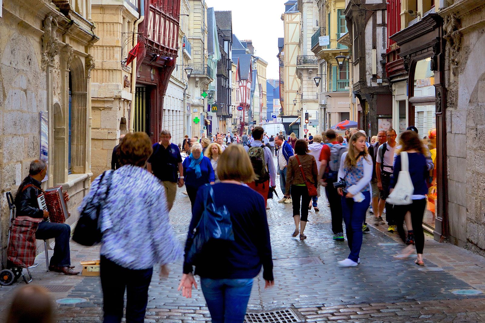 A crowd of people walking down a street.