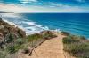 Sand covered steps lead down to the surf of San Diego.