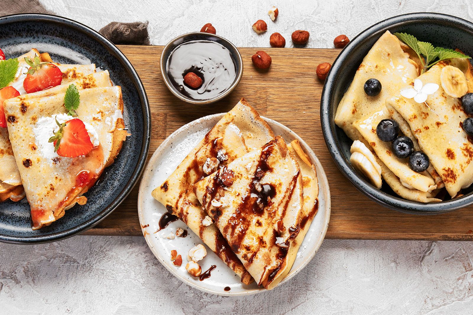 Plates with different variety of crepes. 