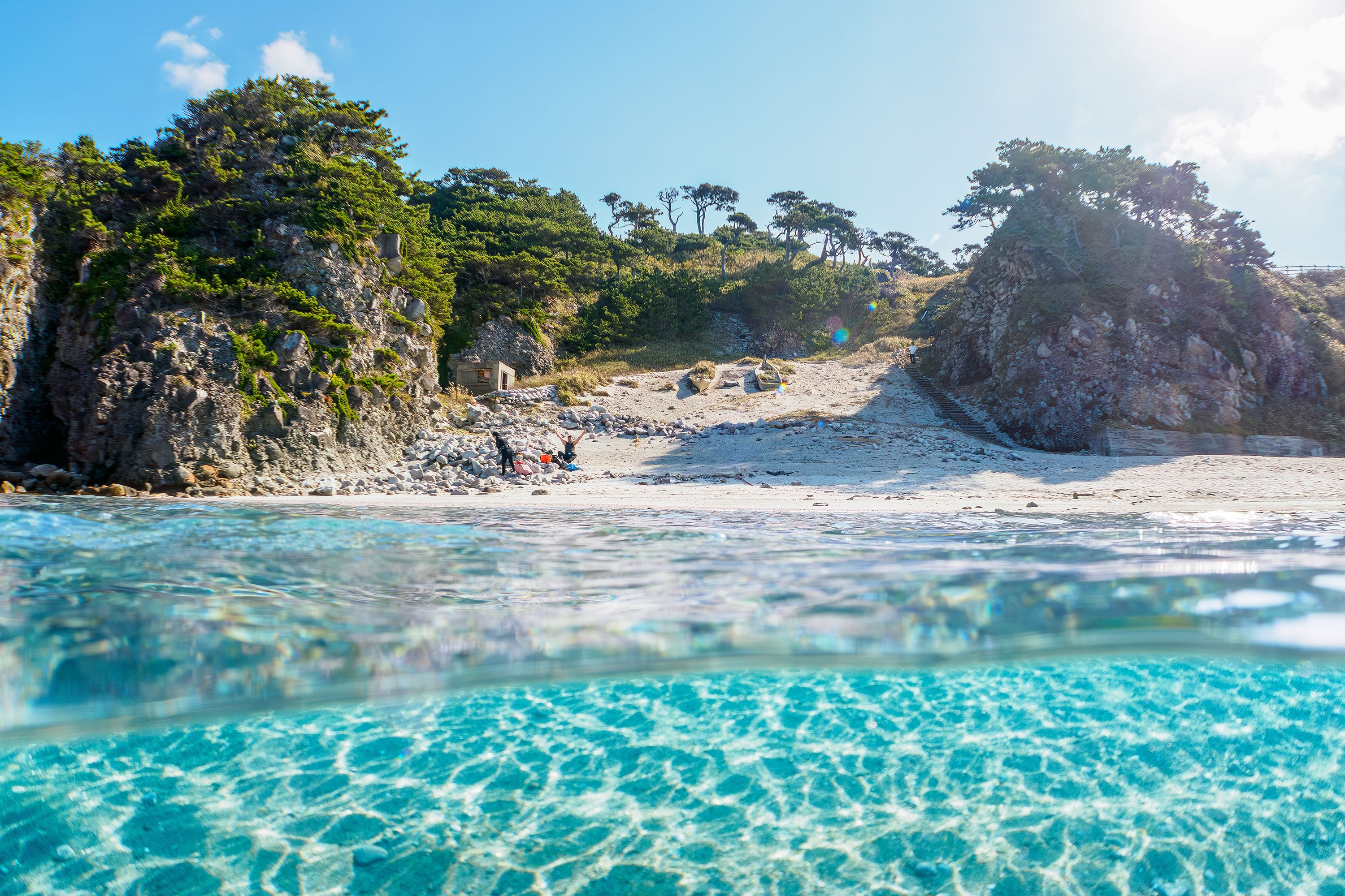 A view of a beach in Tokyo with perspective half in water.