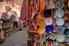 Dishes and rugs on display on a Moroccan souk.