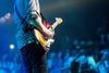 A guitar player in front of a crowd.