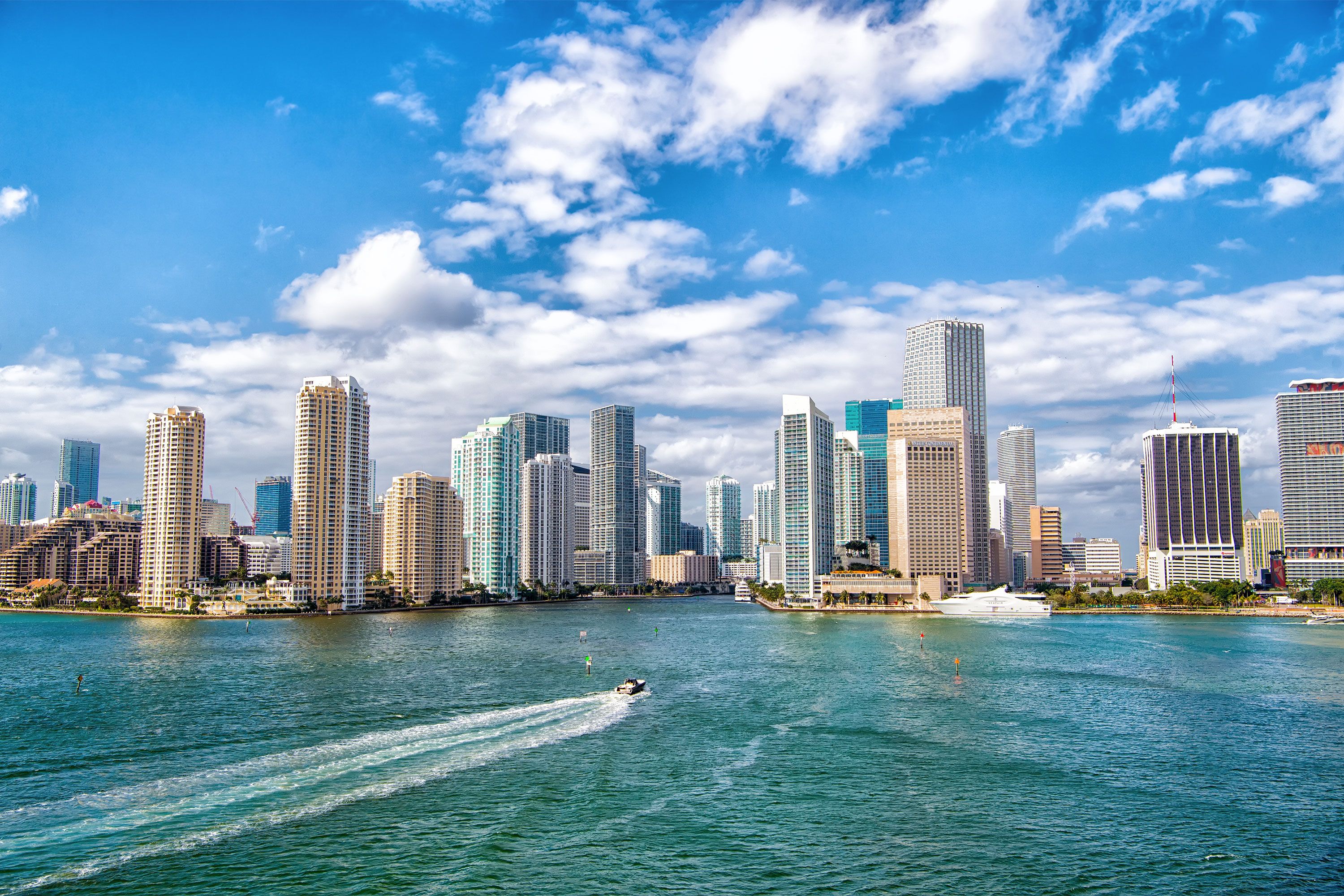 Aerial view of skyscrapers with blue cloudy sky.