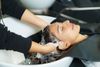 A woman getting her hair shampooed.