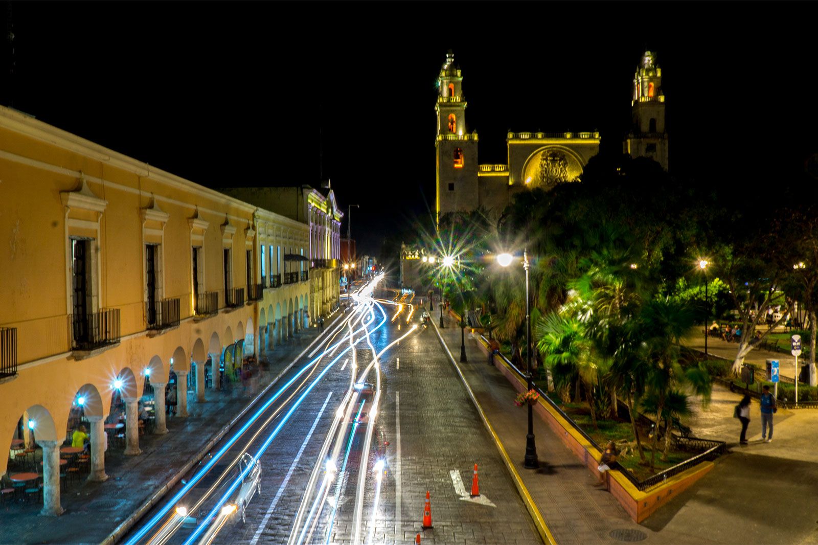 A night view of a street and buildings lit up.