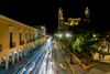 A night view of a street and buildings lit up.
