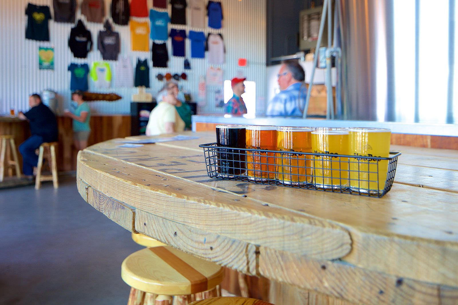 A basket of beer glasses on top of a table in a restaurant.