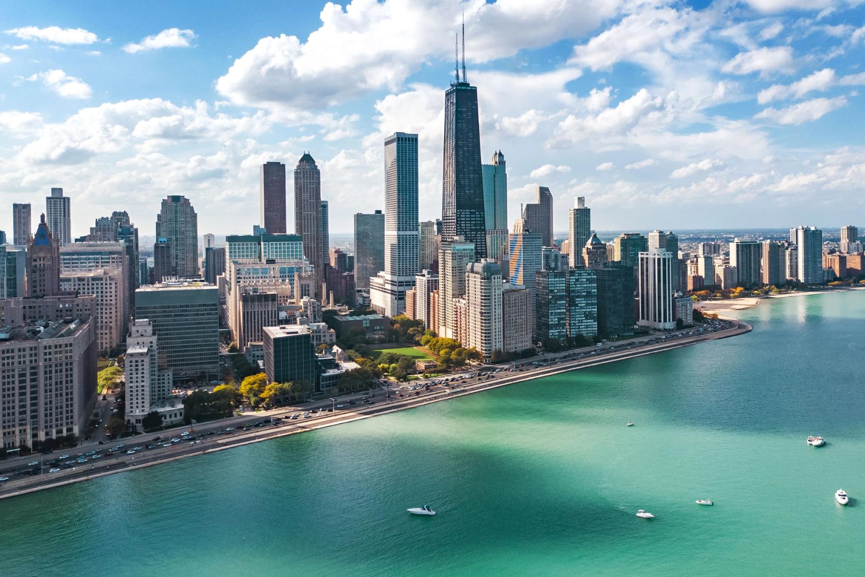 City skyline of Chicago and Lake Michigan on a cloud-filled sunny day.