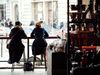 Two women sit at a counter in a cafe