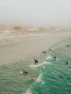 People surf at the beach in Santa Barbara, California